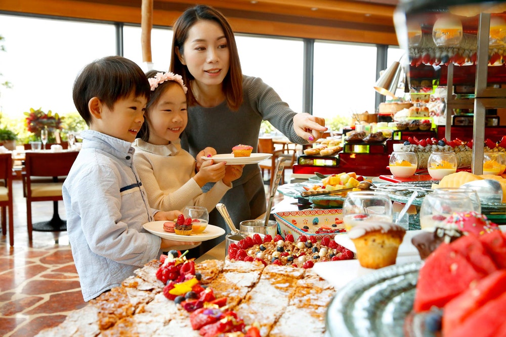 Harbourside restaurant woman and children at dessert station